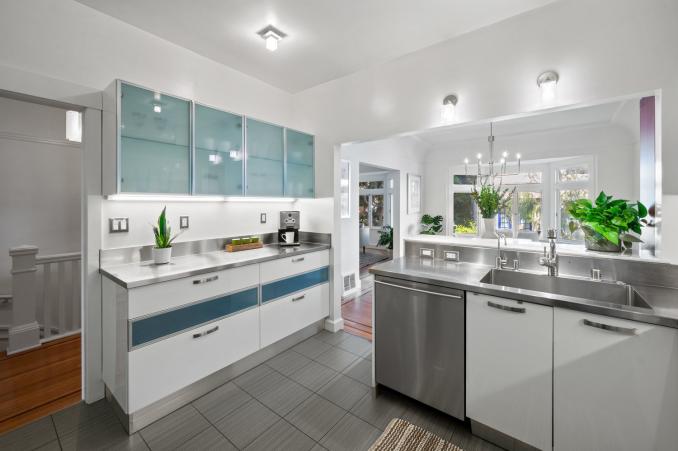 Property Thumbnail: Looking at cabinetry and sink area in kitchen. The upper cabinet doors are a light see through glass. 