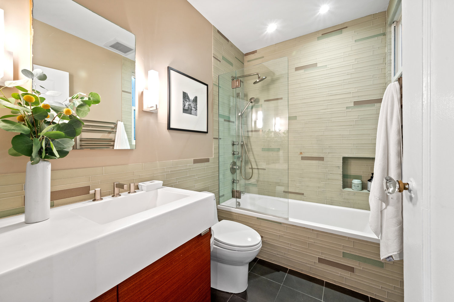 Property Photo: Looking into full bath. Fully updated with glass tile in shower/bath tub. 