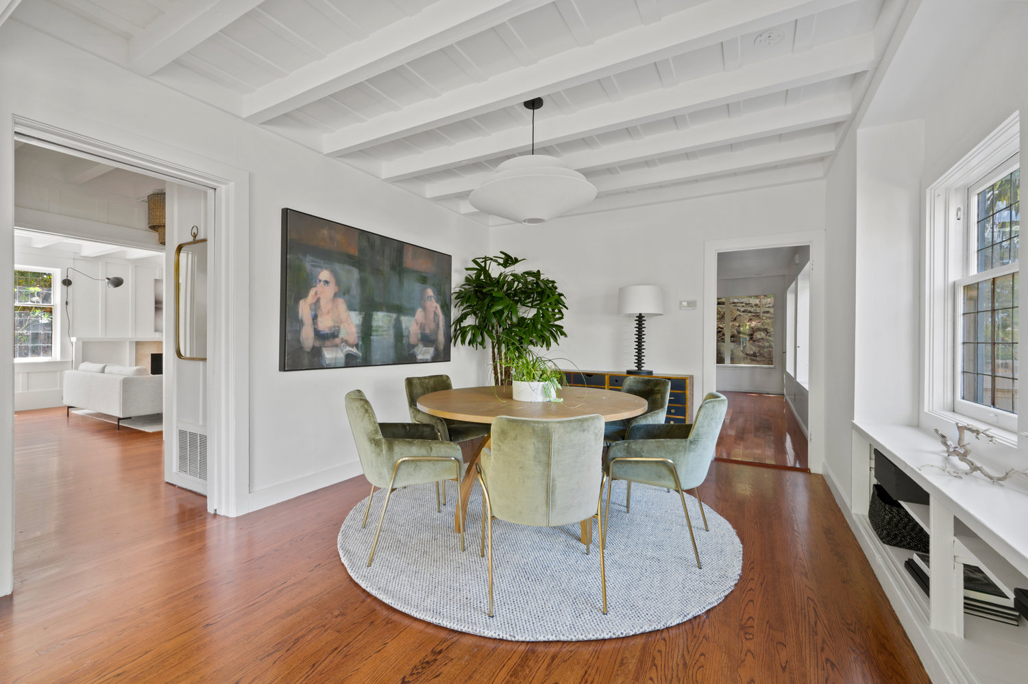 Property Photo: Dining area with lovely large round table. Main entry is doorway to the left. 
