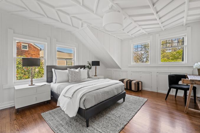 Property Thumbnail: This guest room has stunning chevron wood detailing on the ceiling. There is a queen bed with two bedside tables. 