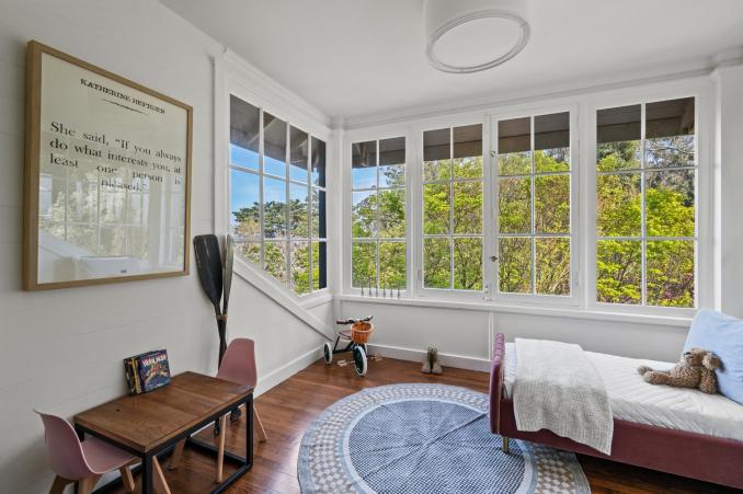Property Thumbnail: Guest room that is staged as a children's room. Harwood floors with nice large windows that look out onto Edgewood. 