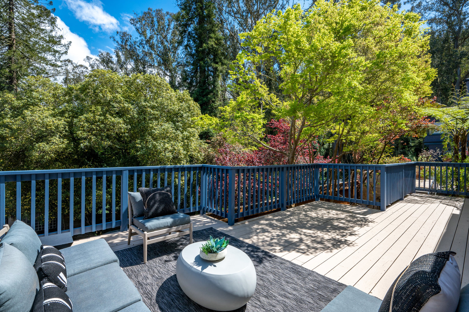Property Photo: Looking out at all the greenery from deck. Lots of trees. 