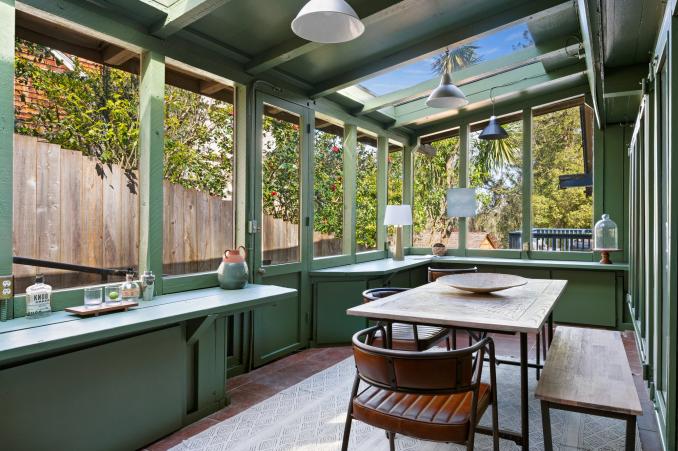Property Thumbnail: Green room off the kitchen that it staged with dining table, bench and chairs. Lots of storage and glass windows all around and skylights. 