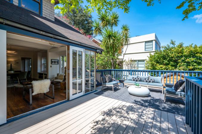 Property Thumbnail: Photo of deck area with french doors that are open and lead into living/dining space. 