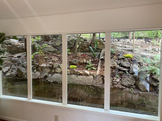 Property Thumbnail: Photo of windows in kitchen that look out to the rocky hill behind the home. 