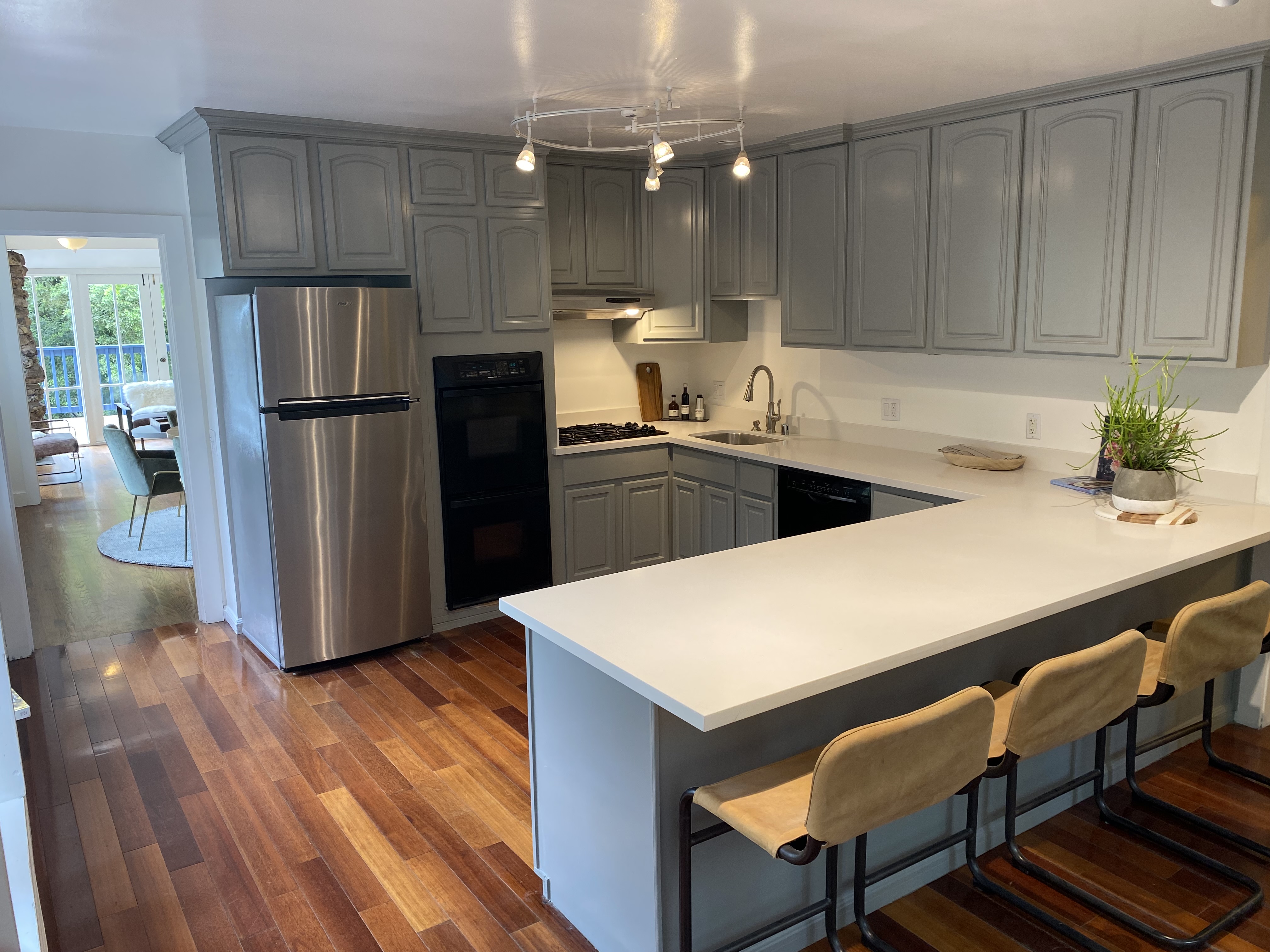 Property Photo: Kitchen has L shaped counter. There is an area for three barstools at counter. 