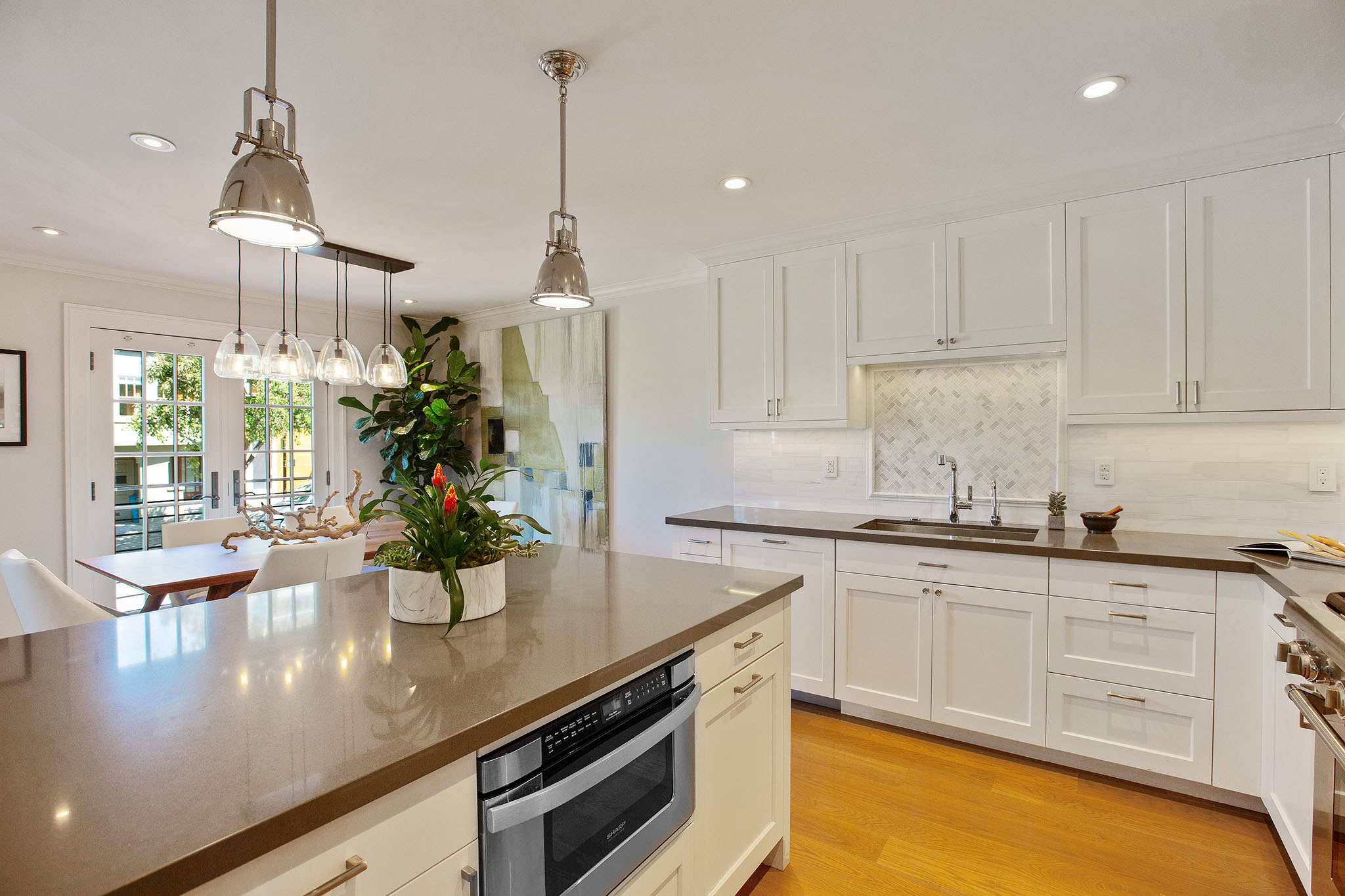 Property Photo: Kitchen has an island that has stone counter top with built in microwave. 