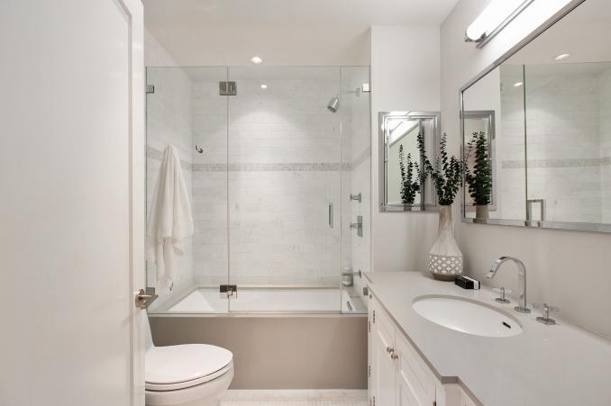 Property Thumbnail: First bathroom has a tub/shower combo. There is one sink and grey countertops. 