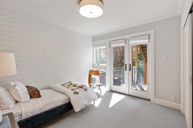 Property Thumbnail: Second bedroom is staged as child's room. There is a also french doors that open up to back yard. 