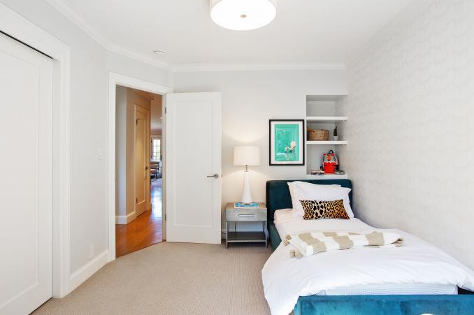 Property Thumbnail: Second bedroom has light grey carpet and built in shelves above bed. 