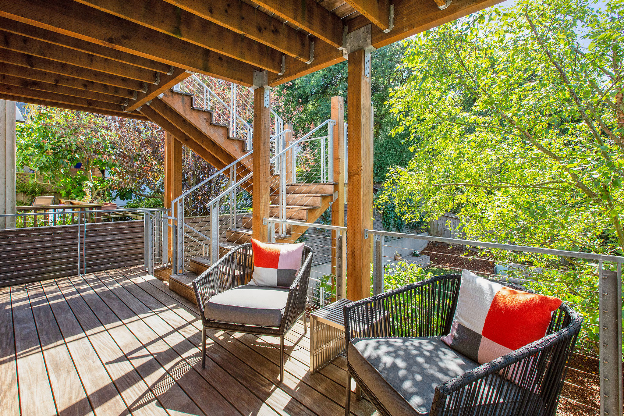 Property Photo: Deck area. There is a sitting area with chair and love seat. 