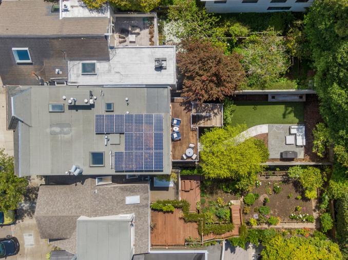 Property Thumbnail: Aerial from above 1521 Cole. You see the roof, solar panels, and full shot of yard. 