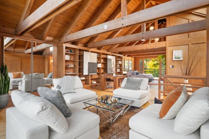 Property Thumbnail: Looking over sitting area in upper level. Features stunning wood detailing, large beamed ceilings. 