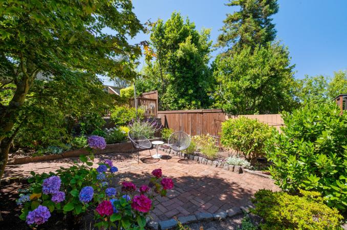 Property Thumbnail: Back yard is fences in and has small sitting area in the middle. 