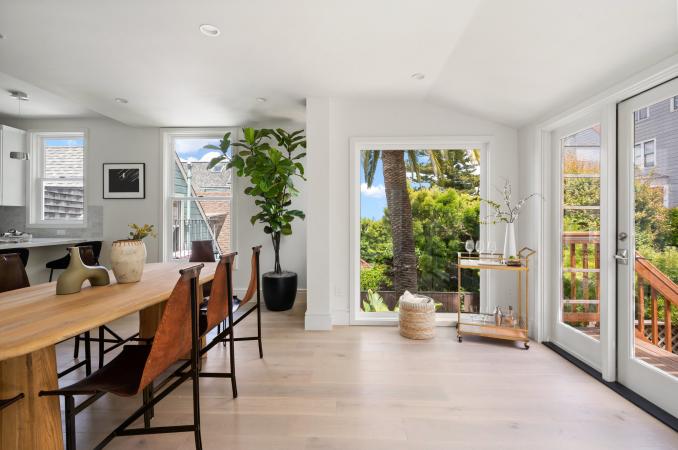Property Thumbnail: Looking at sitting area in back of living space. There is floor to ceiling window that looks out to neighbors palm tree. 