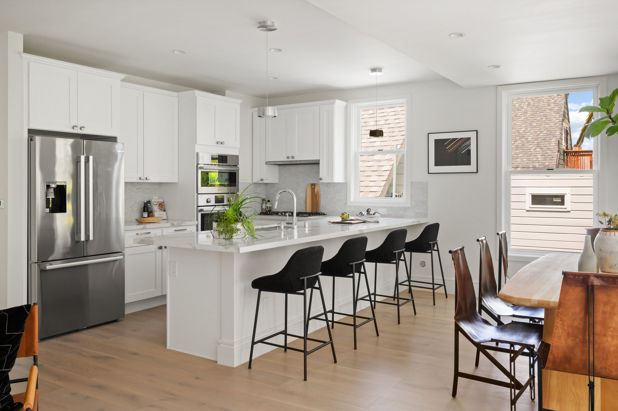 Property Photo: The kitchen has all white cabinets and stainless steel appliances.