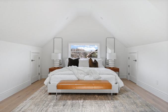Property Thumbnail: Primary bedroom is on upper level. There is a window centered above bed. 