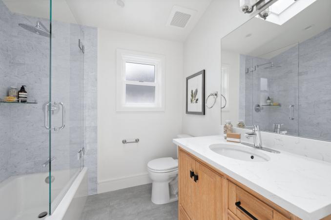 Property Thumbnail: Another photo of the bathroom showing vanity and tub/shower combo. 