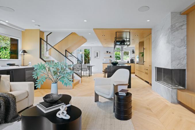 Property Thumbnail: Looking over living room towards the kitchening. Electric fireplace to the right.