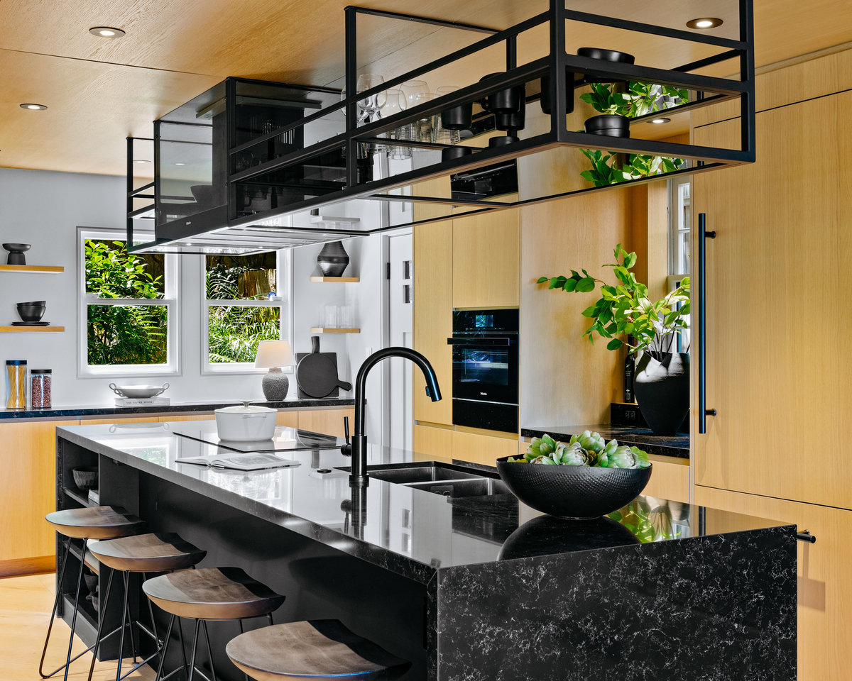 Property Photo: Has light wood cabinetry in the kitchen with dark counter tops.
