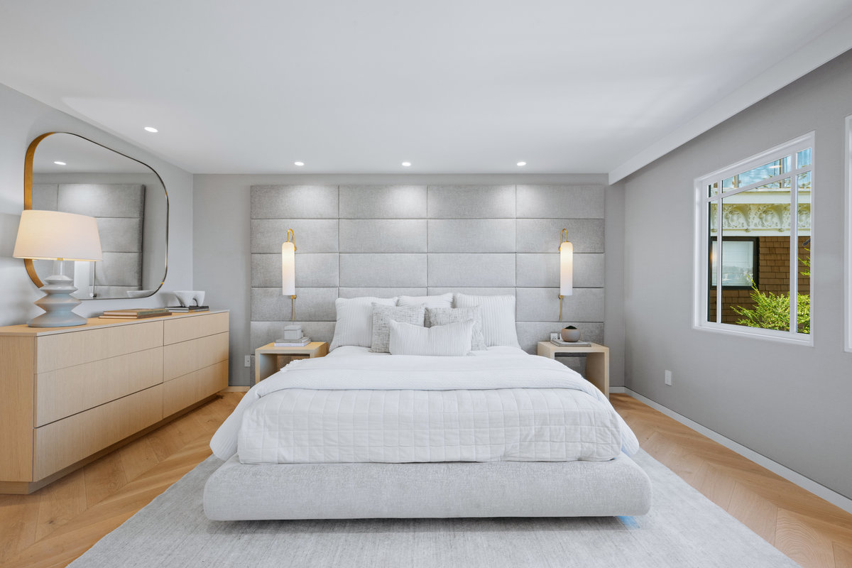 Property Photo: There is a large king bed with sconces on each side.