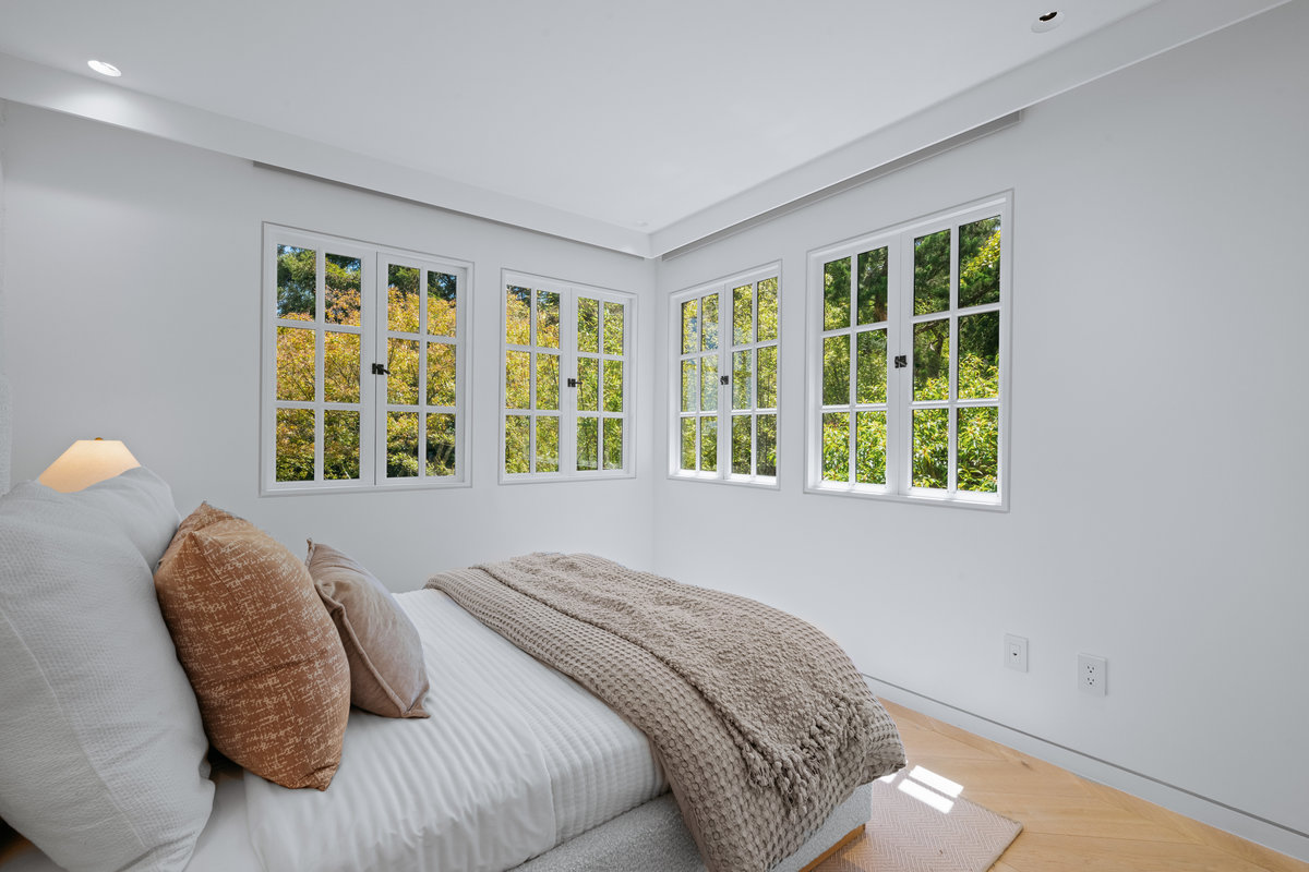 Property Photo: Guest bed that is across from primary. There is a twin bed, and lots of windows letting in lots of natural light.