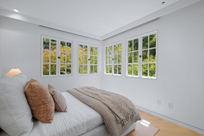 Property Thumbnail: Guest bed that is across from primary. There is a twin bed, and lots of windows letting in lots of natural light.