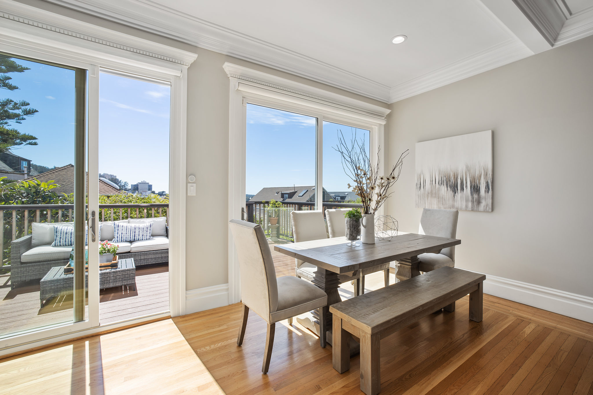 Property Photo: Eat-in kitchen space with large windows and doors, featuring a partial view of the adjoining deck