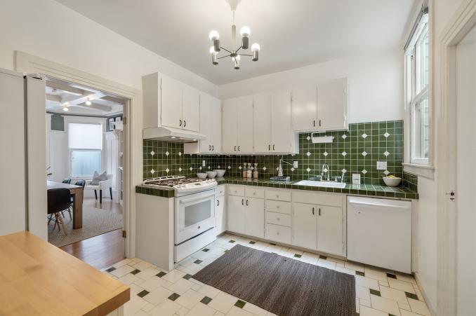 Property Thumbnail: Kitchen, with green backsplash and white cabinets 