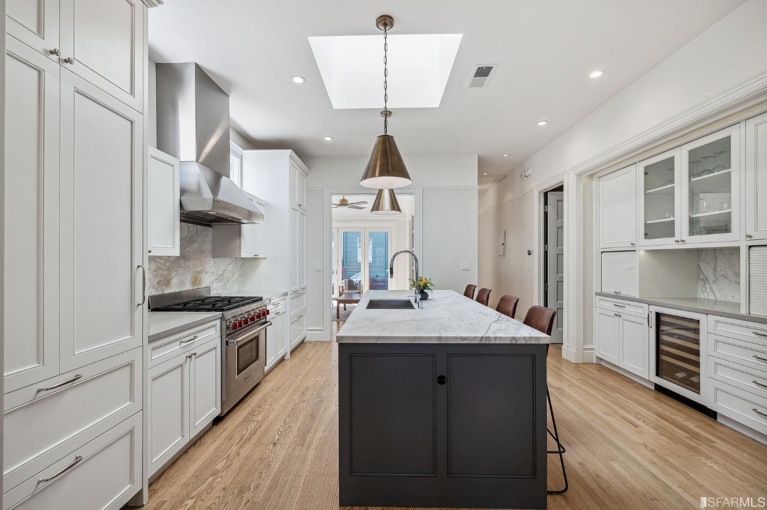 Property Photo: View of the kitchen at 286 Fair Oaks St, showing a large skylight, modern lighting and wood floors