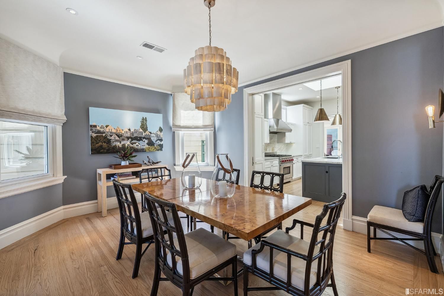 Property Photo: Formal dining room showing a large chandelier and wood floors