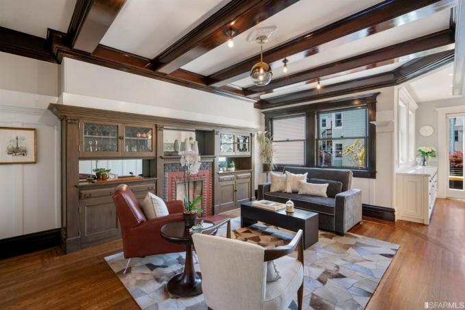 Property Thumbnail: Living area with wood beamed ceilings and fireplace 