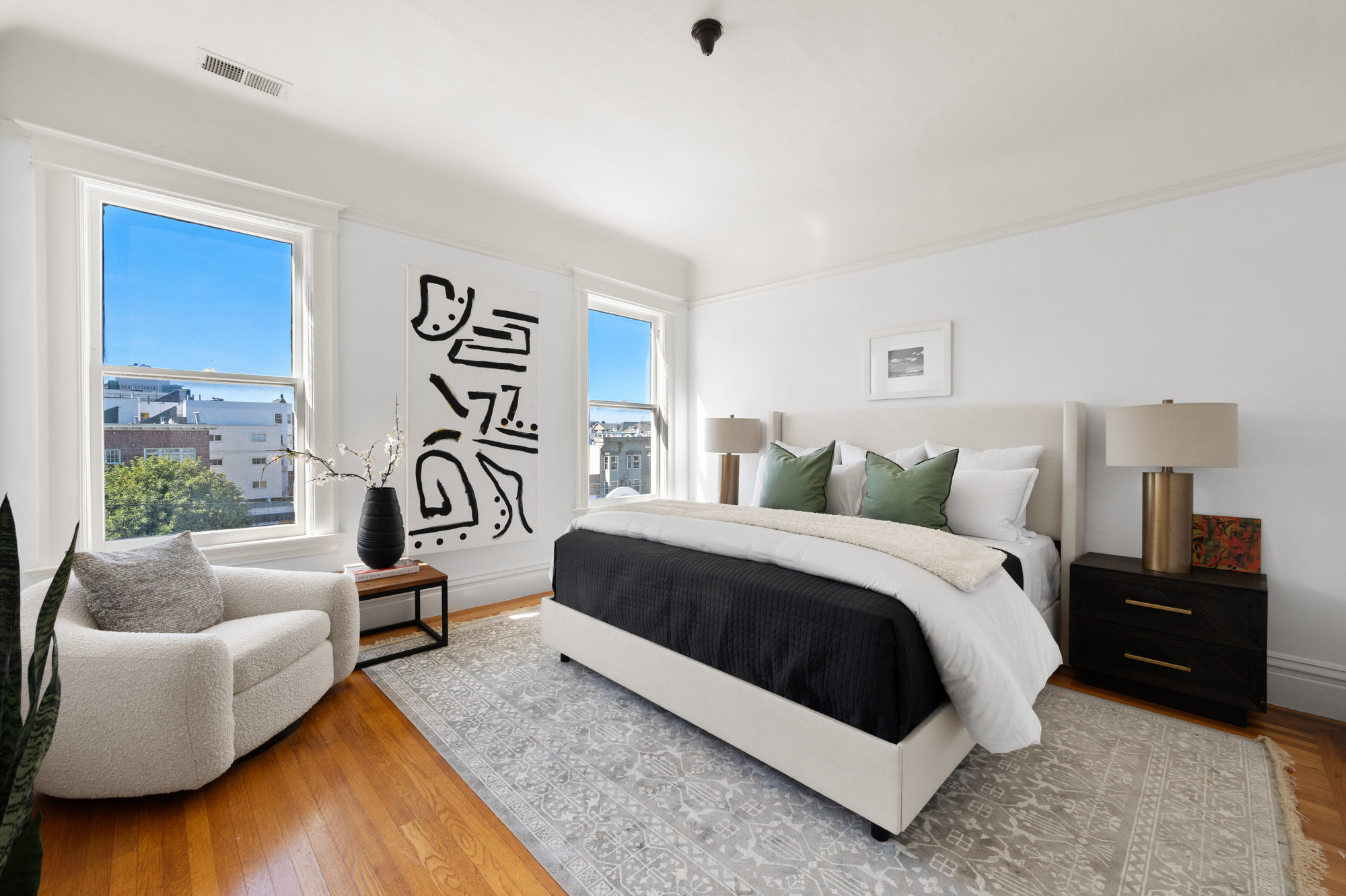 A large bedroom with lots of natural light and views of San Franisco