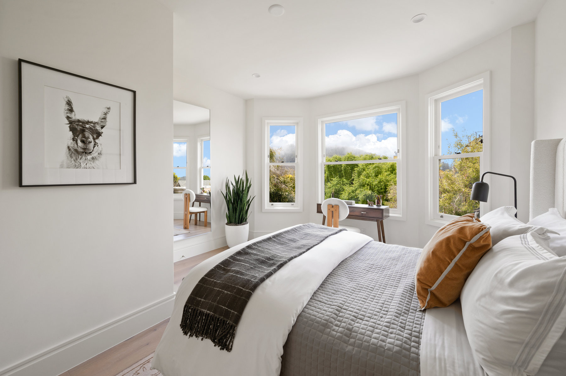 A large bedroom with bay windows and a desk are at 234 Downey Street in San Francisco