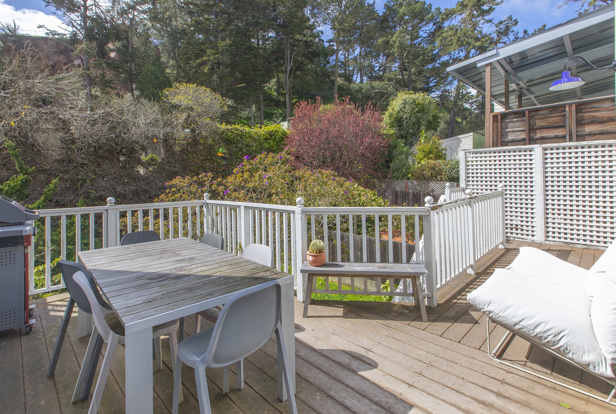 View of a private deck and yard with an outdoor living area