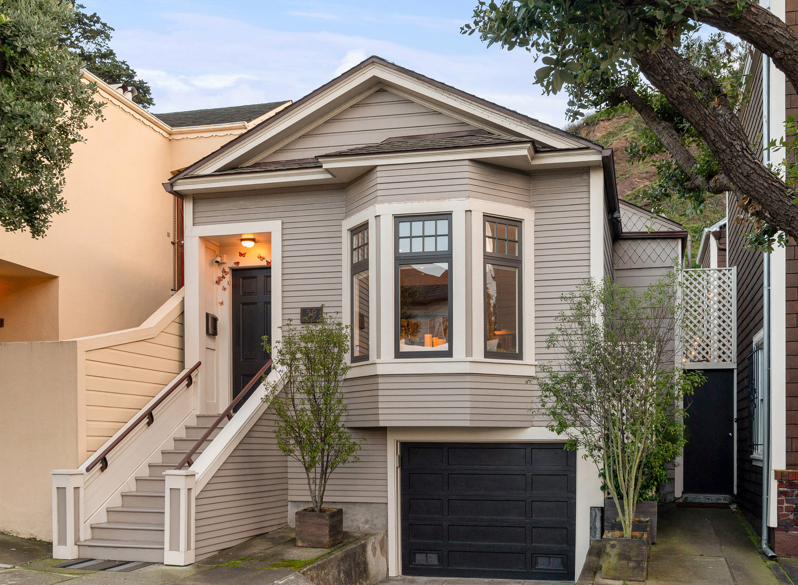 Front exterior view of 39 Carmel, a private sale in Cole Valley, showing a one story home