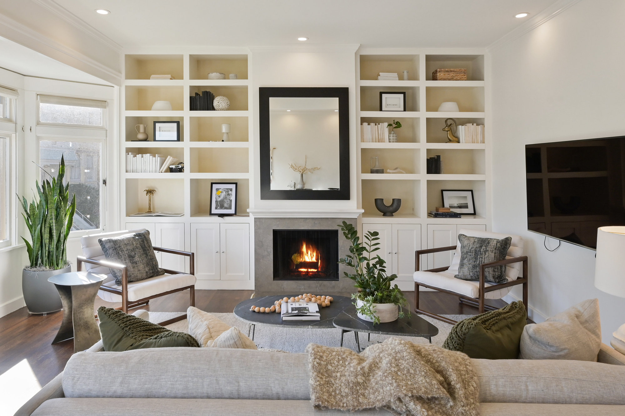 View of the living room at 39 Delmar, showing a fireplace and white built-in cabinets