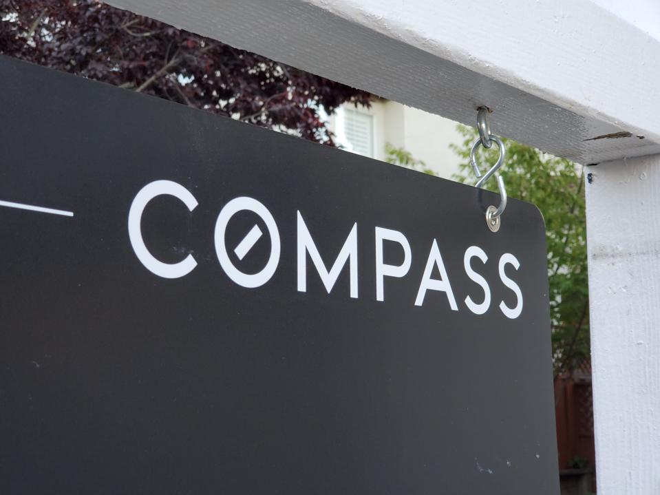A sign for Compass real estate