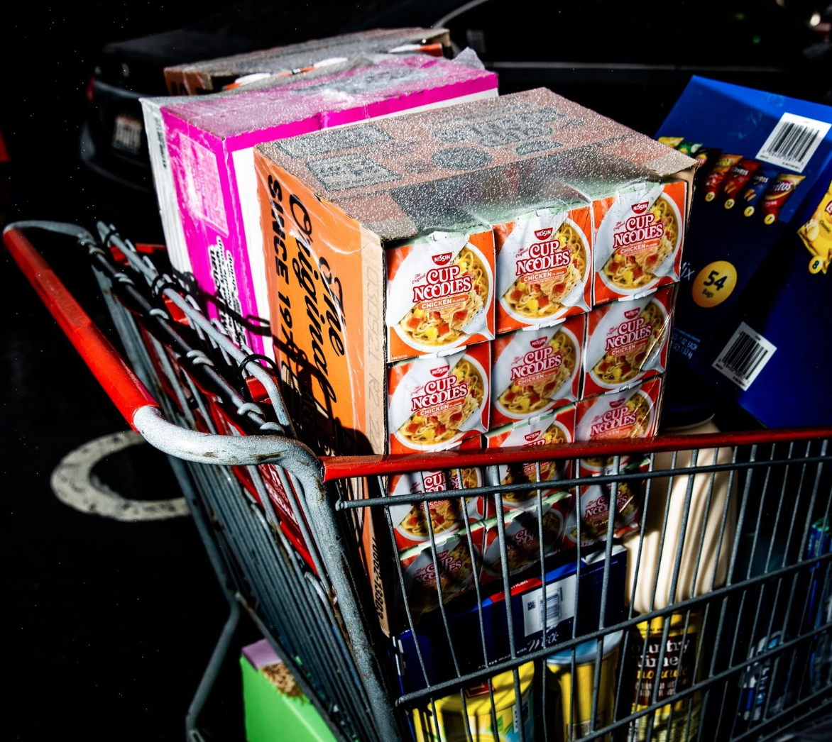 A grocery cart filled with boxed food