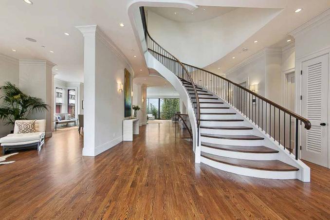 Property Thumbnail: Large entry area with wood floors and grand staircase 