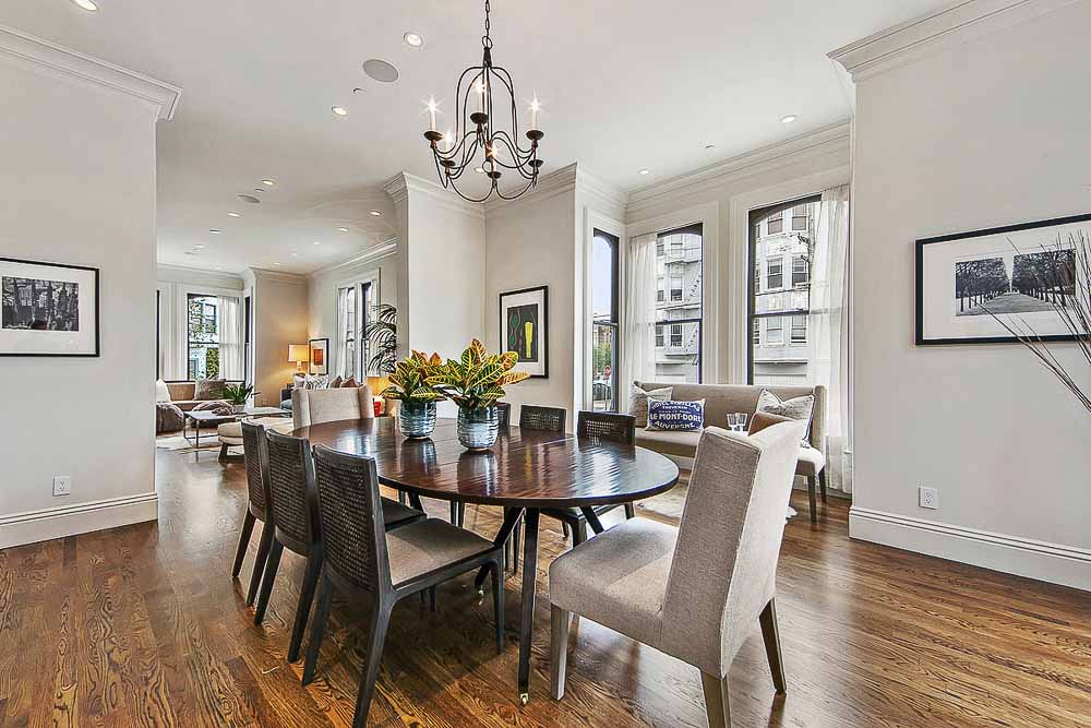 Property Photo: Dining area with chandelier and wood floors