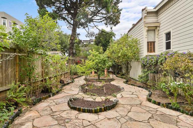 Property Thumbnail: A stone path with lush landscaping 