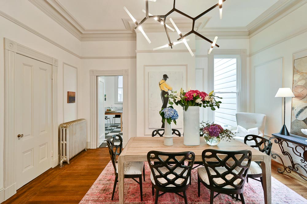 Property Photo: View of the formal dining room, featuring wood floors and crown moulding 