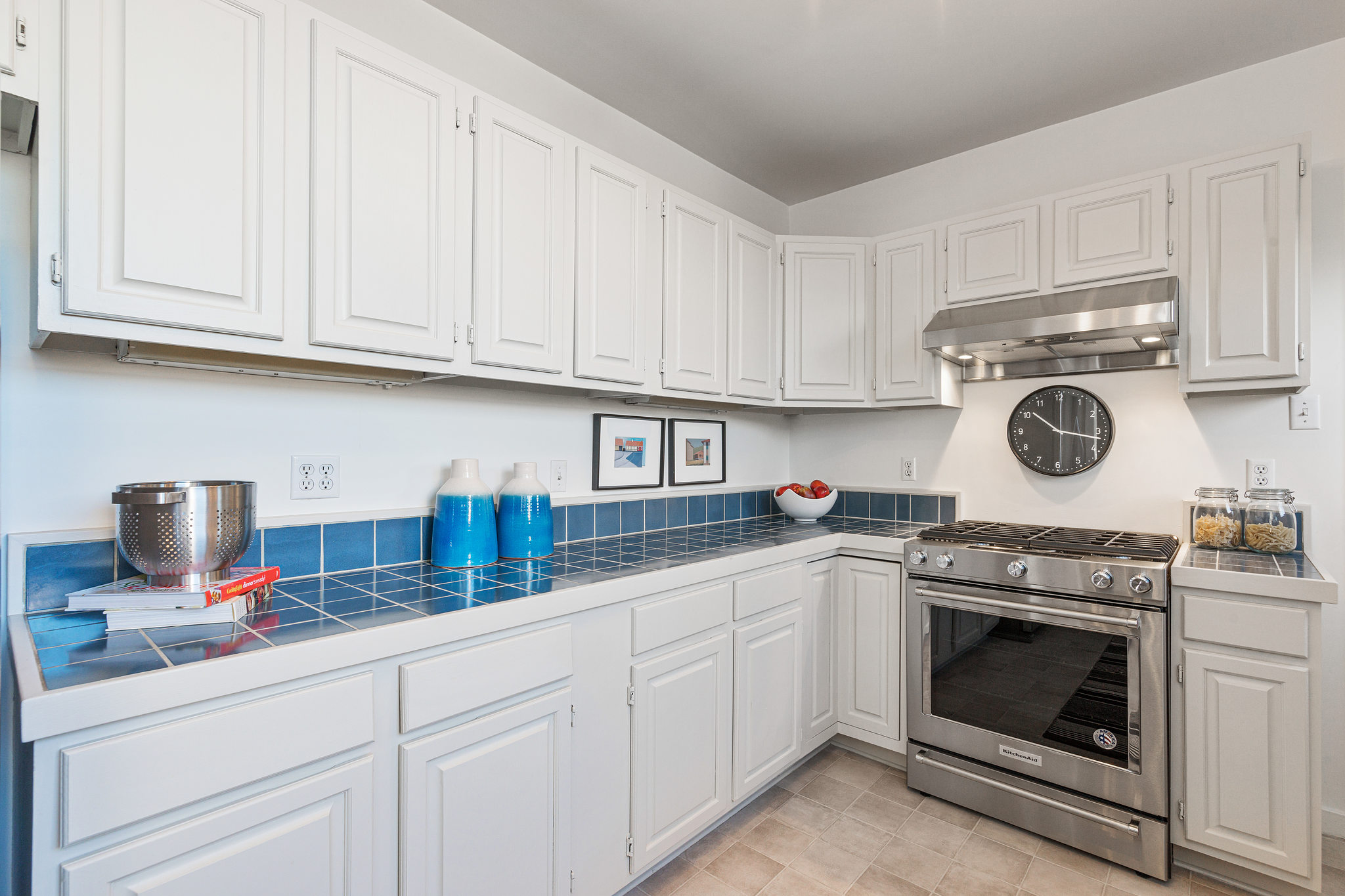 Property Photo: View of the kitchen, showing the primary cooking area and blue tile counter-tops