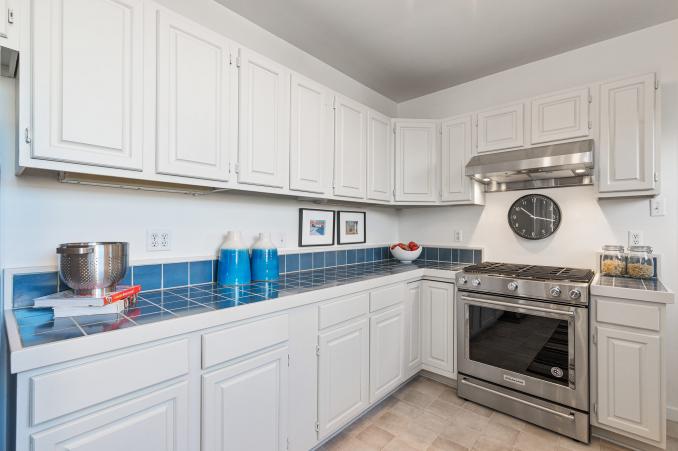 Property Thumbnail: View of the kitchen, showing the primary cooking area and blue tile counter-tops