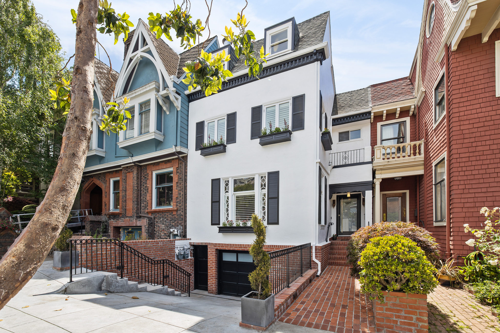 Property Photo: Front exterior view of 929 Ashbury Street, featuring a cheery white facade