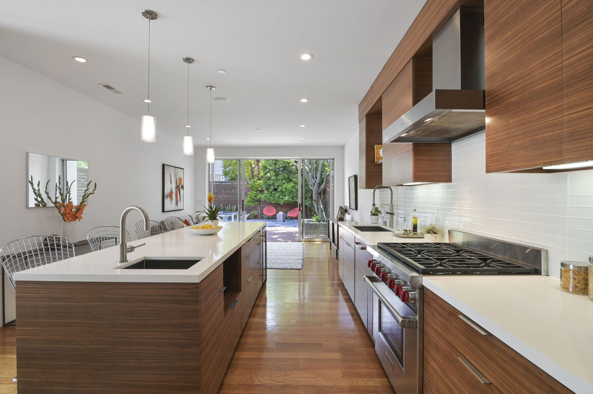 Property Photo: View of the lower unit kitchen, featuring wood floors and an island 