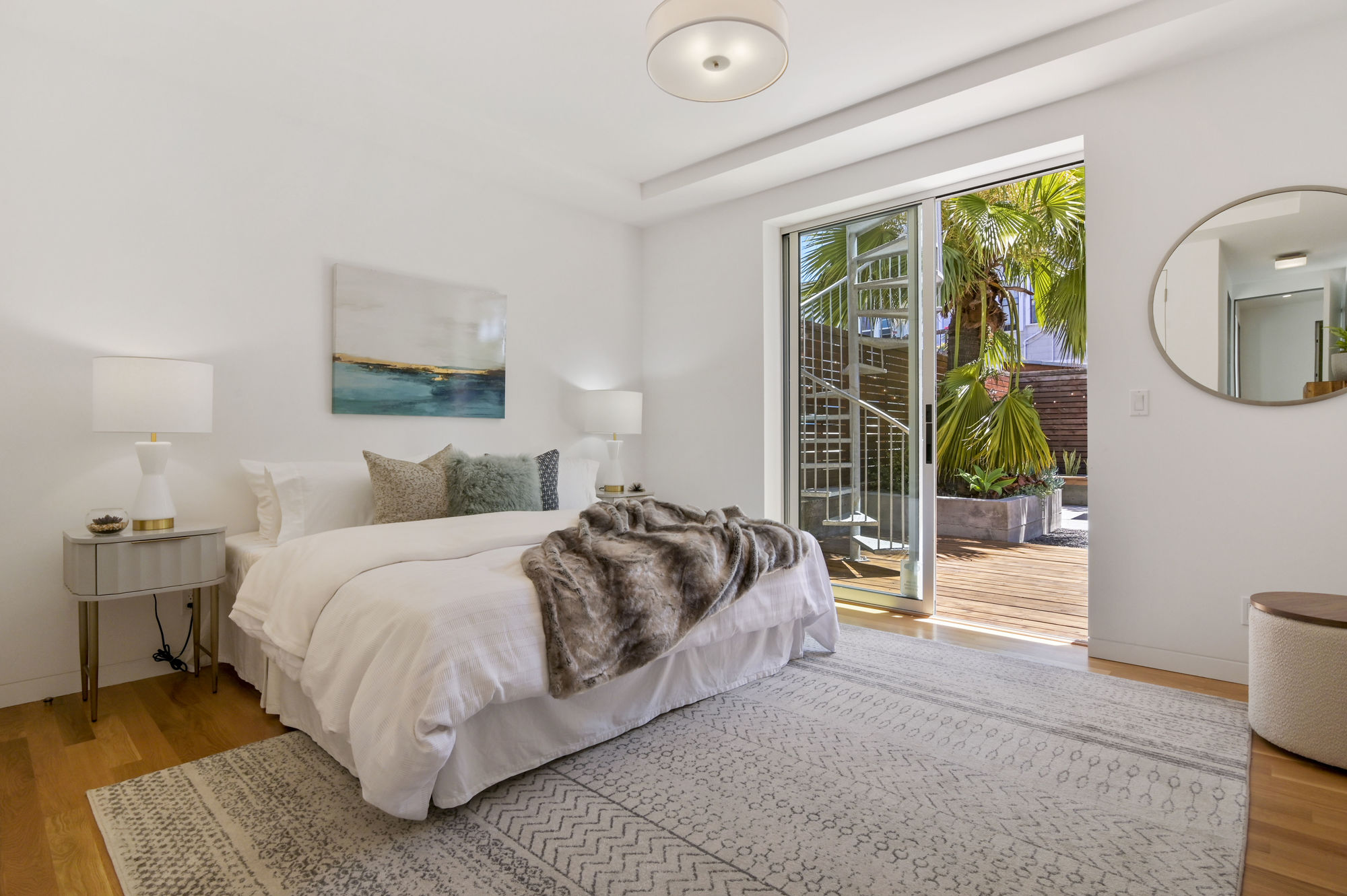 Property Photo: View of a bedroom overlooking the outdoor living area and spiral staircase 