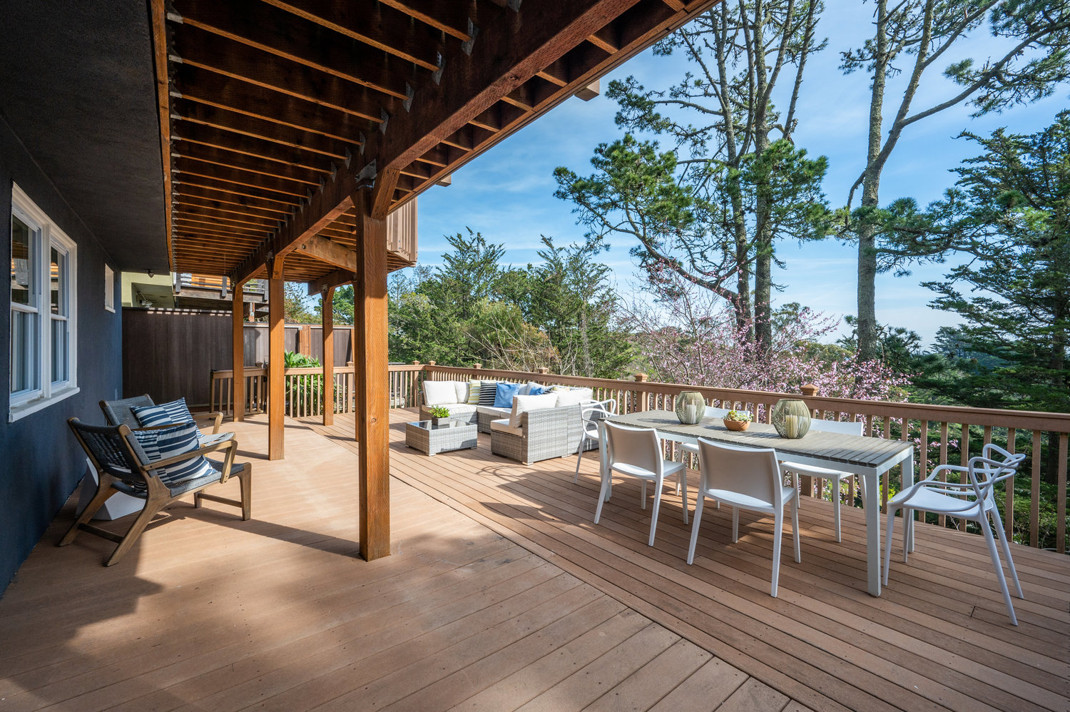 Property Photo: View of the lower deck, showing a large outdoor living and dining area