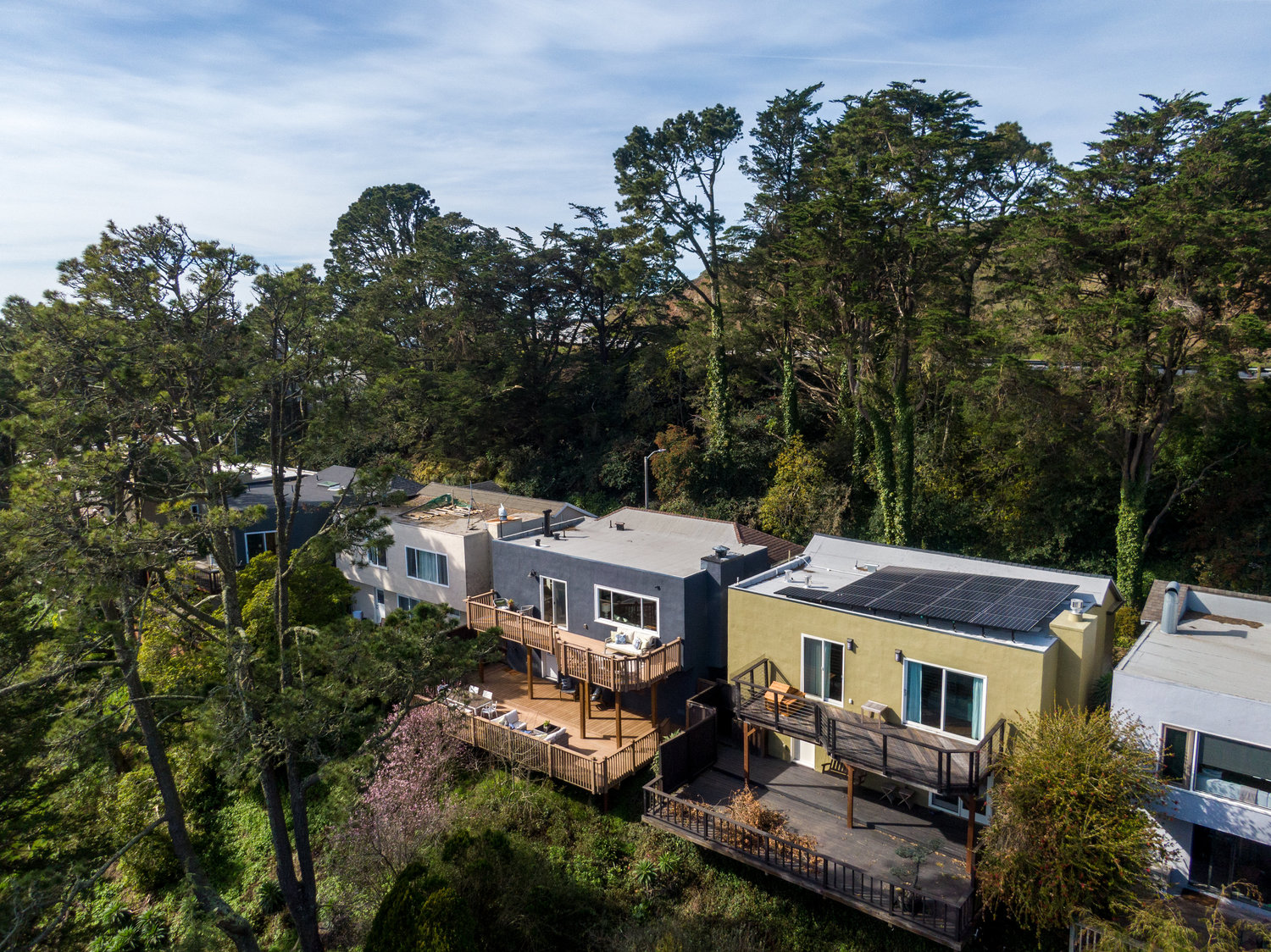 Property Photo: Side aerial view of 156 Midcrest, showing the home surrounded by trees 